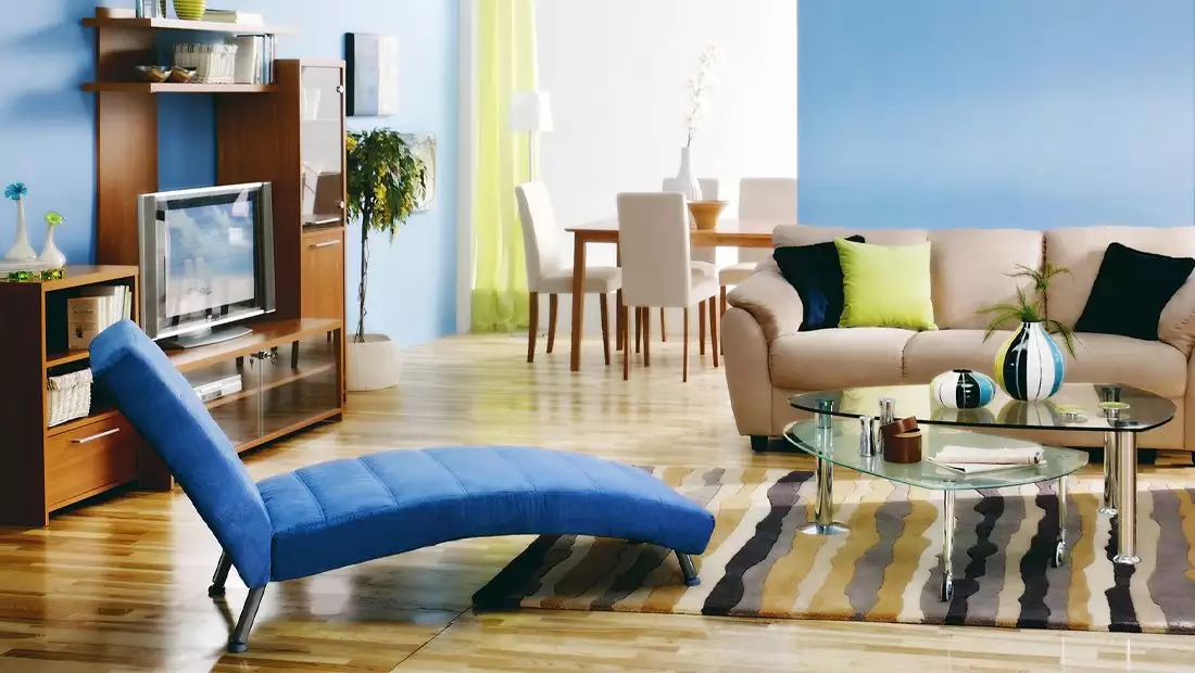 Blue Living Room with Wood Floors and Modern Blue Chaise and Striped Rug