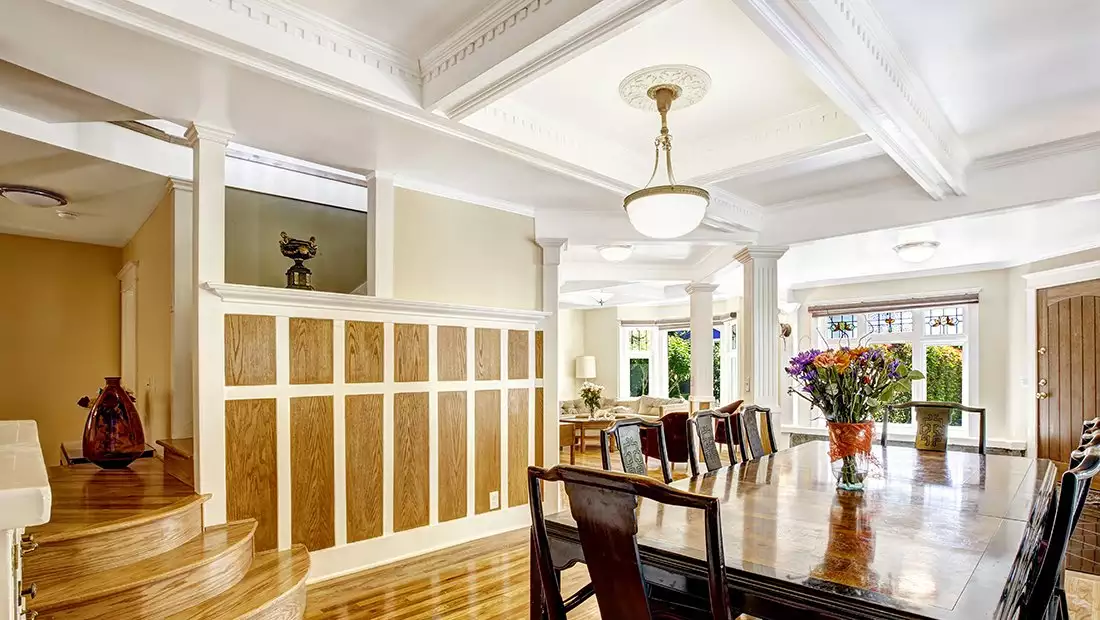 Ornate Living Room featuring Contrasting Wood Millwork on Walls and Ceiling