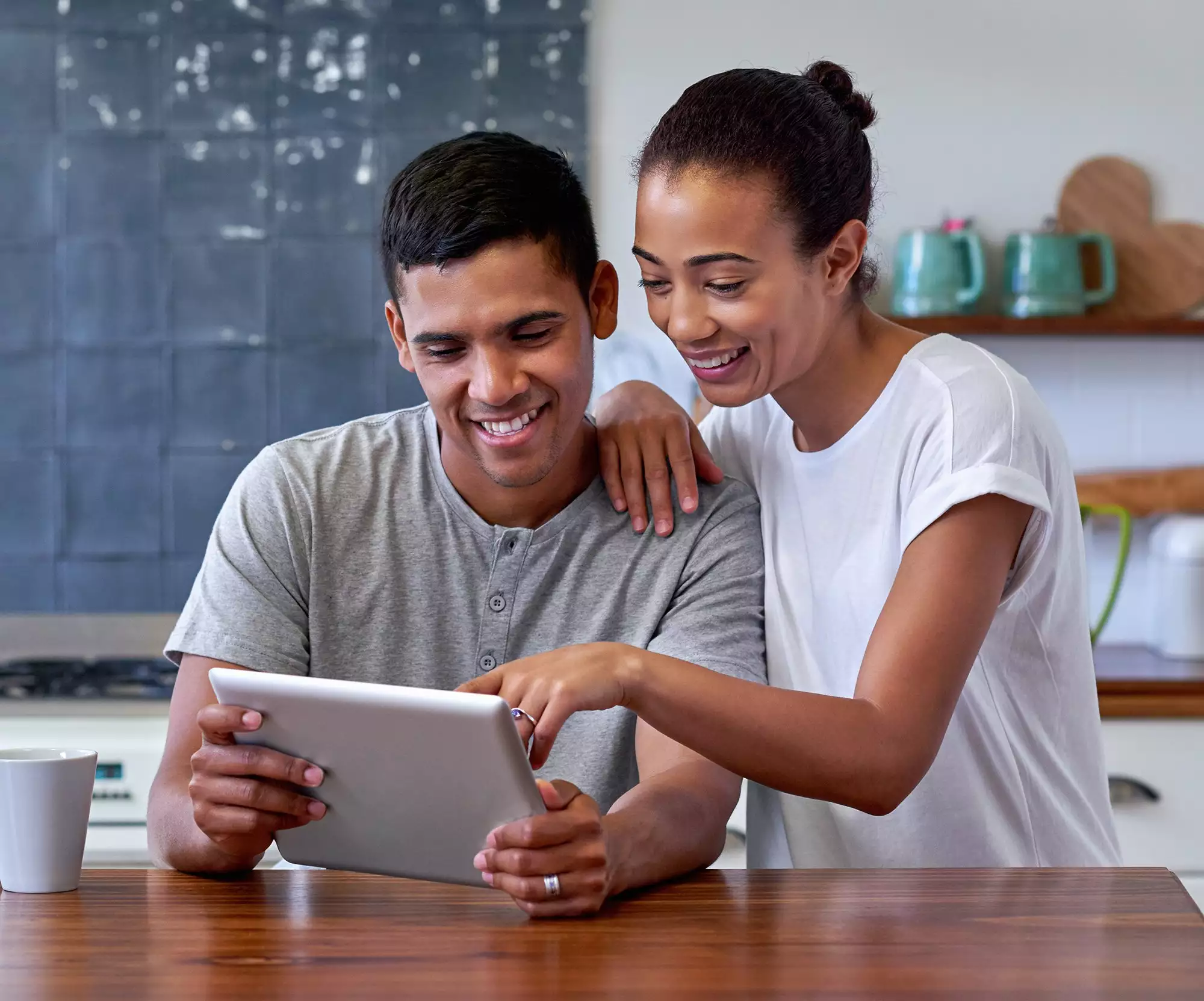 Smiling Couple Looking at a Tablet